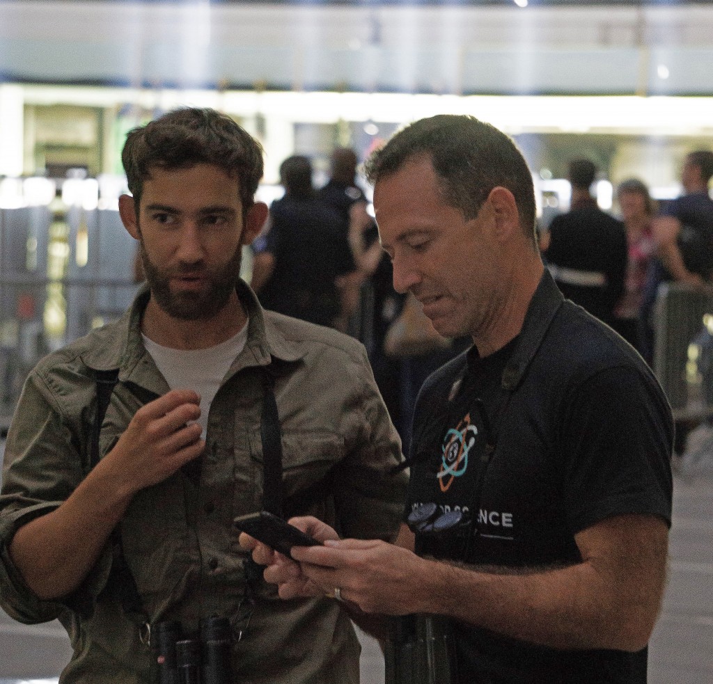 Cornell Lab of Ornithology's Dr. Andrew Farnsworth (right), checking with BirdCast radar maps on his phone to predict bird migrations through New York City. Photo: NYC Bird Alliance