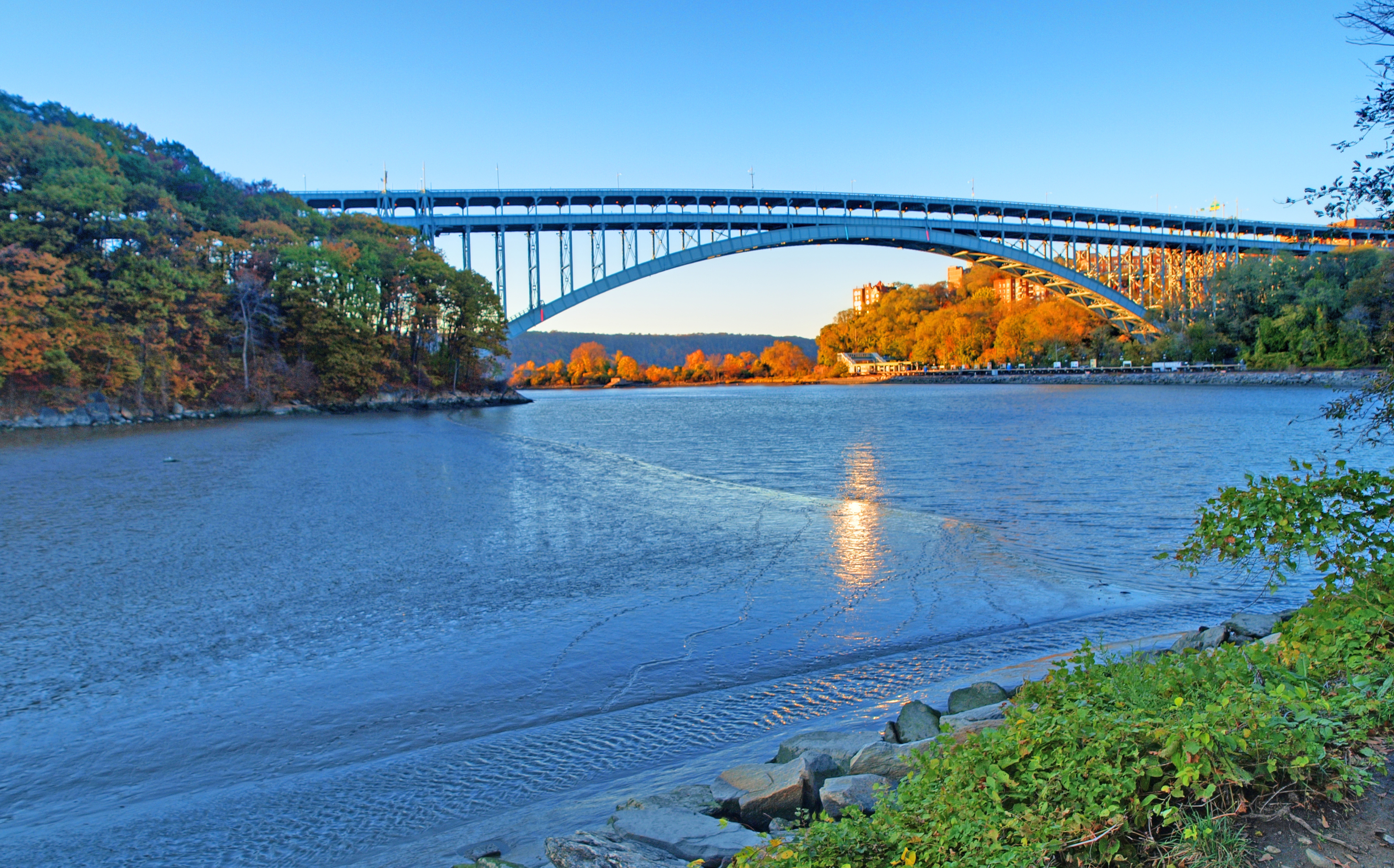 Late afternoon light paints Spuyten Duyvil Shorefront Park in orange tones (viewed across Spuyten Duyvil Ceek from Inwood Hill Park in Manhattan). <a href="https://www.flickr.com/photos/steveguttman/5155511637/" target="_blank">Photo</a>: Steve Guttman/<a href="https://creativecommons.org/licenses/by-nc-nd/2.0/" target="_blank">CC BY-NC-ND 2.0</a>