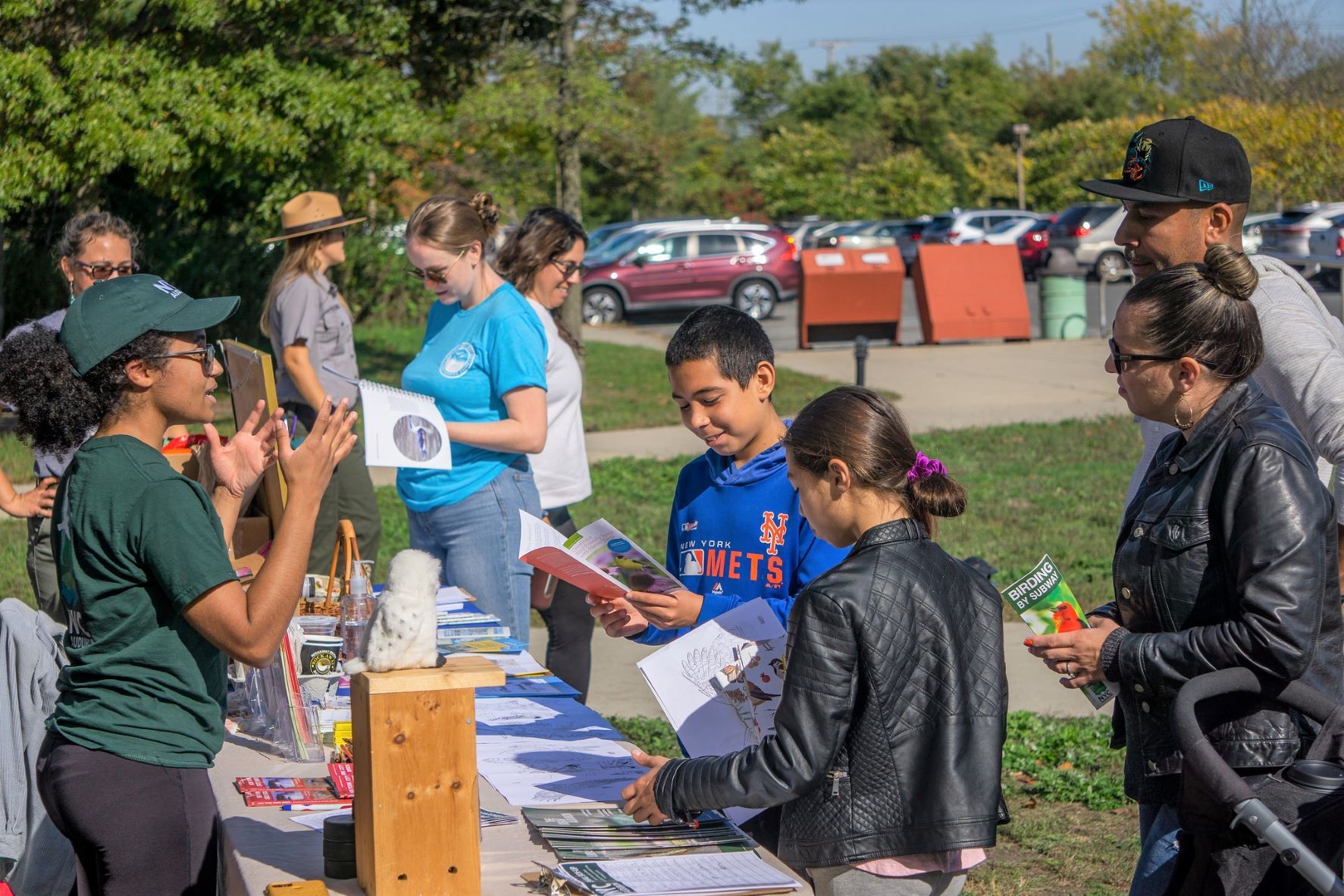 Roslyn Rivas shares NYC Bird Alliance’s work with a young family at the Raptorama! festival in Jamaica Bay. Photo: Andrew Maas