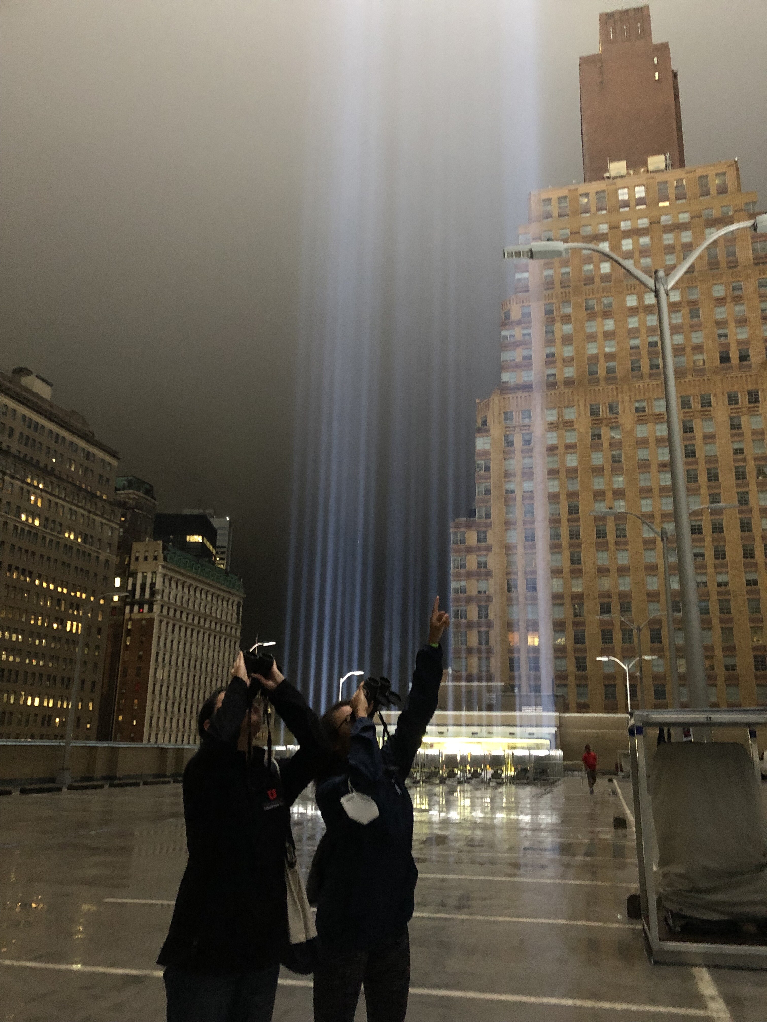 Community Science Manager Katherine Chen and Public Programs Manager Roslyn Rivas monitor the Tribute in Light for birds caught in the lights. Photo: NYC Bird Alliance