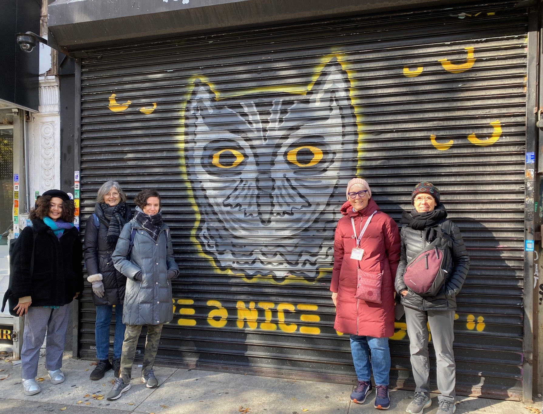 Audubon Mural Project tour participants and leader Leigh Hallingby pose in front of "Whiskered Screech-Owl by artist Snoeman located at 3631 Broadway in Manhattan. Photo: Leigh Hallingby