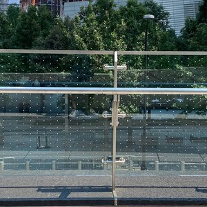 Bird-safe glass installed along the glass railway at World Trade Center's Liberty Park. This bird-safe measure was implemented in part due to pressure from NYC Bird Alliance volunteers who were finding many dead birds that had collided with the reflective glass. Photo: NYC Bird Alliance